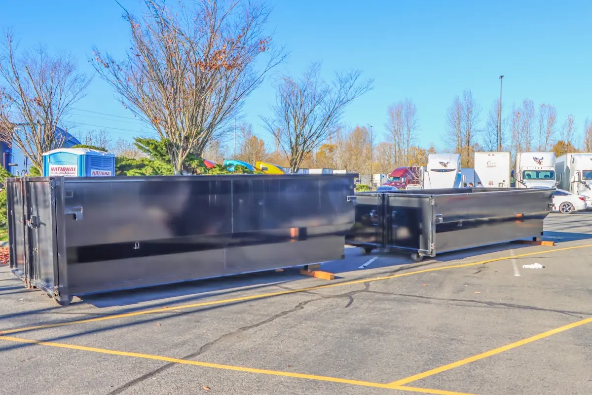 Professional dumpster rental service with roll-off container on residential driveway in Payette